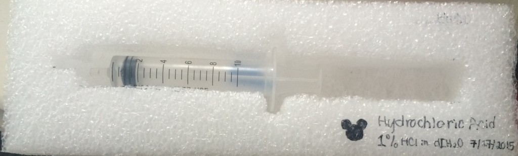 1-2% HCl solution in a syringe.